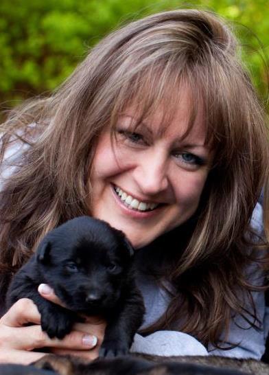 Owner and Breeder Julie Marlow holding a German Shepherd Puppy